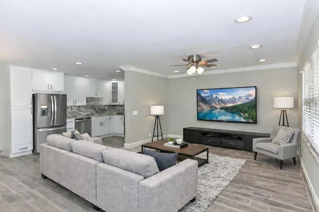 a kitchen with granite countertop a refrigerator stove and microwave