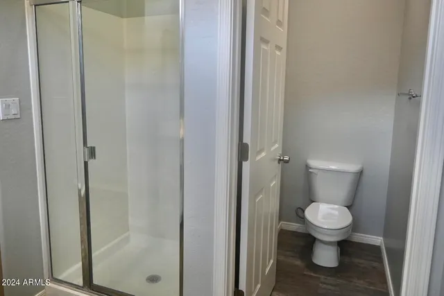 a white toilet sitting next to a bathroom sink