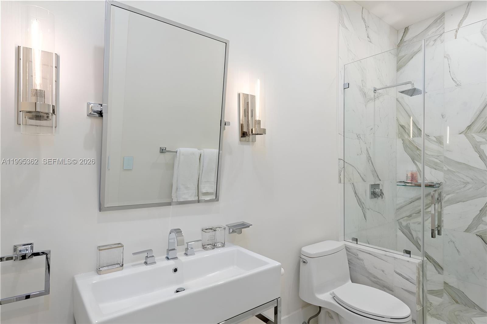 2575 Pine Tree Drive Miami Beach, FL 33140 - Photo 16 of 32 a bathroom with a sink toilet and shower