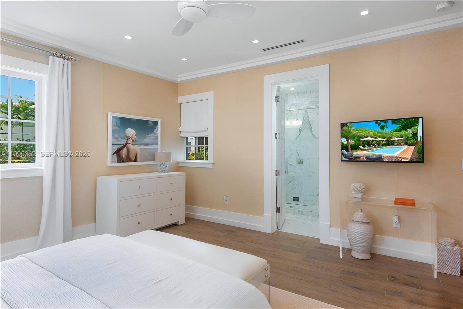 2575 Pine Tree Drive Miami Beach, FL 33140 - Photo 17 of 32 a bedroom with a bed and a view of bathroom