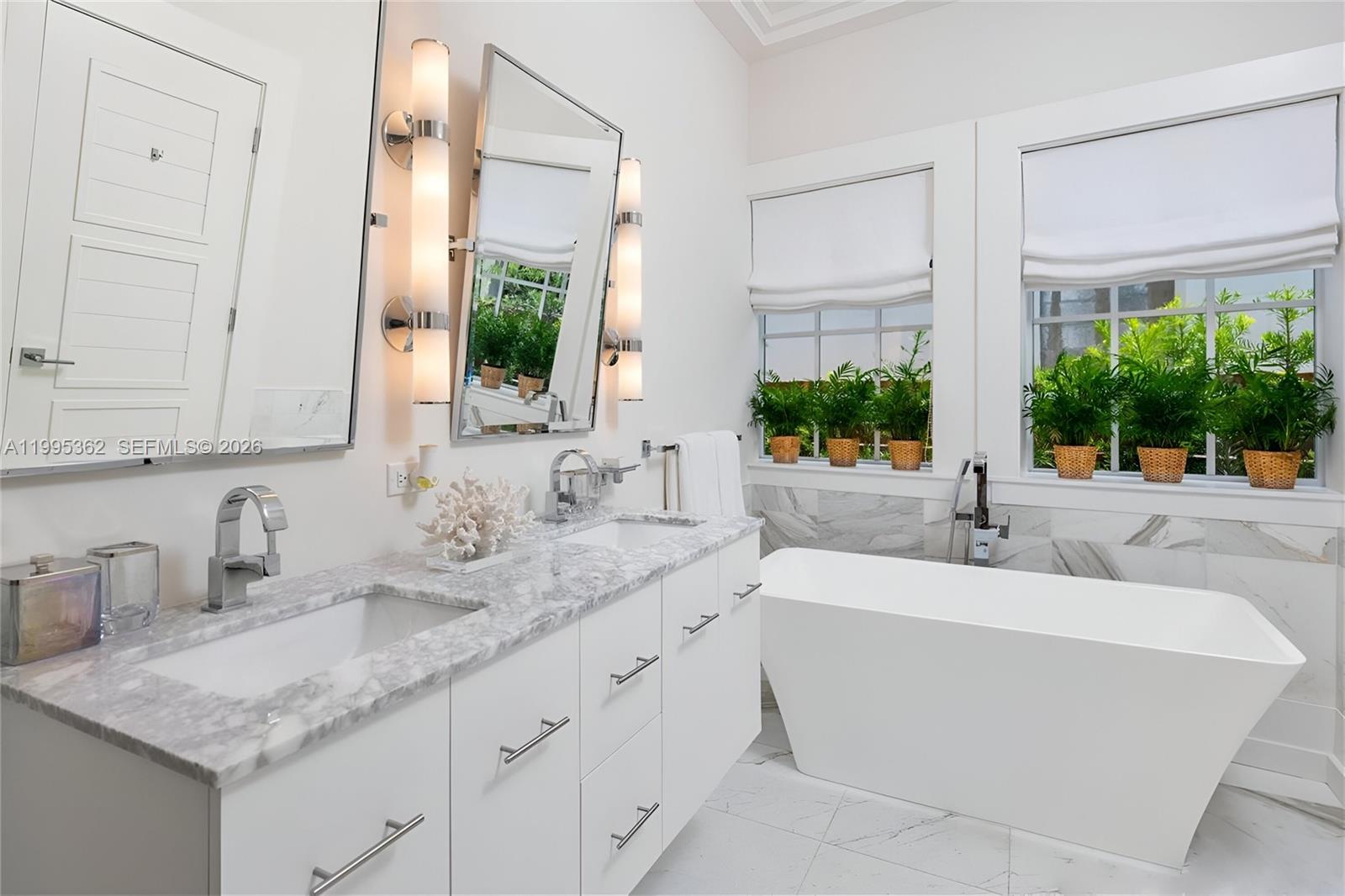 2575 Pine Tree Drive Miami Beach, FL 33140 - Photo 18 of 32 a bathroom with a granite countertop sink and a mirror
