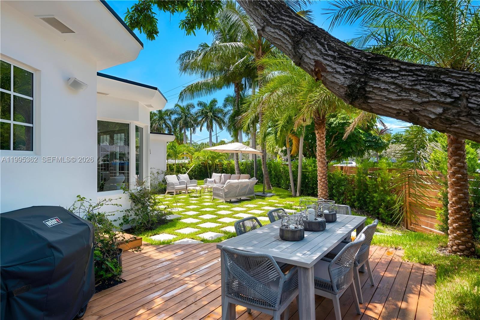 2575 Pine Tree Drive Miami Beach, FL 33140 - Photo 30 of 32 a view of an outdoor sitting area with furniture