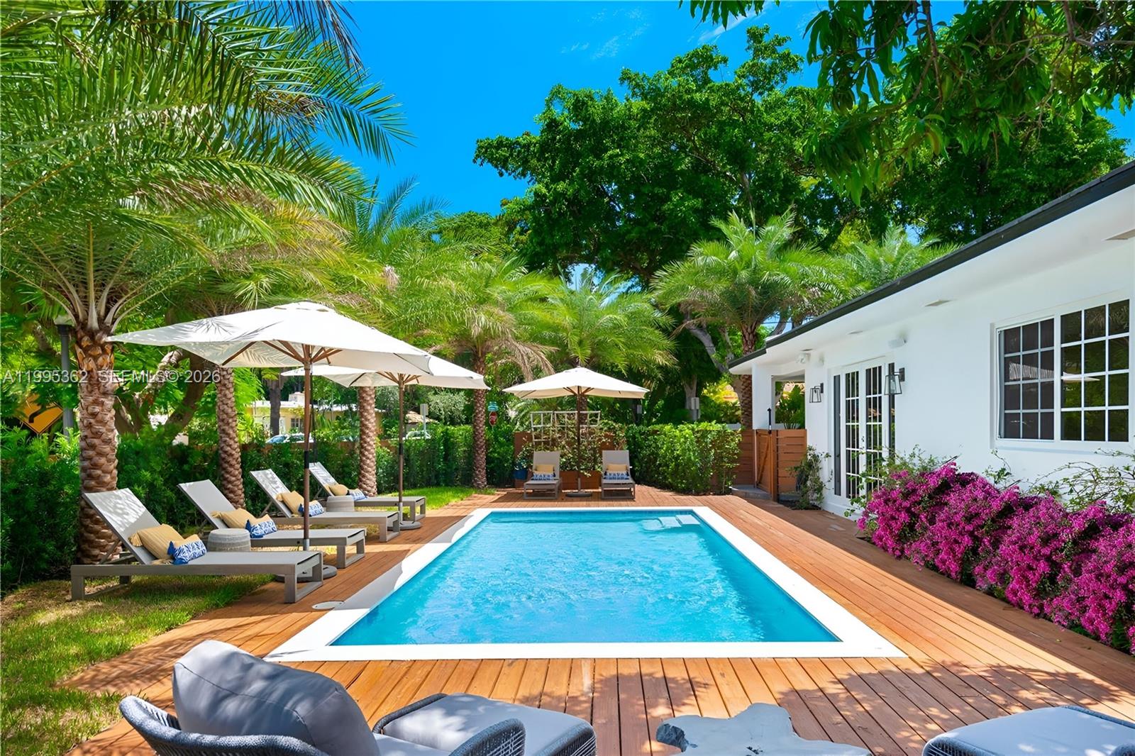 2575 Pine Tree Drive Miami Beach, FL 33140 - Photo 31 of 32 a view of outdoor space yard deck patio and swimming pool