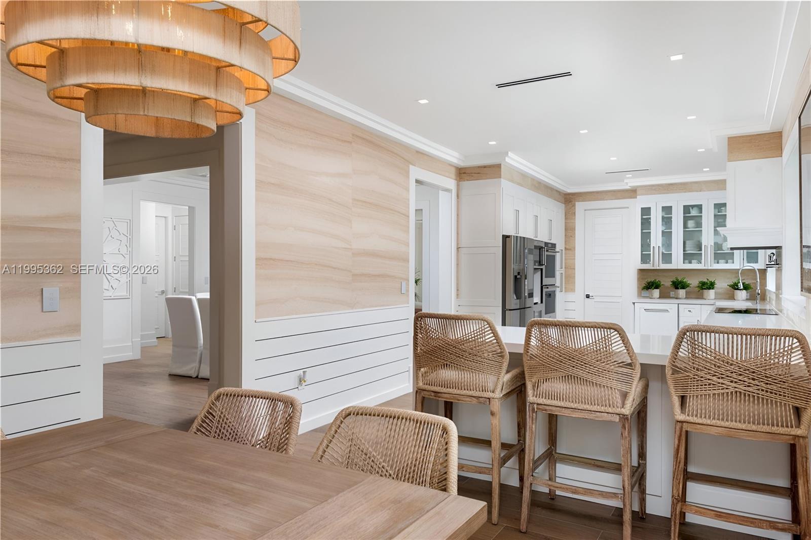 2575 Pine Tree Drive Miami Beach, FL 33140 - Photo 7 of 32 a dining room with furniture and a chandelier