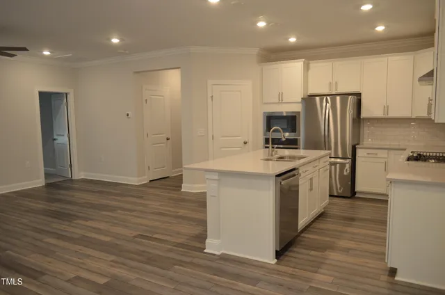 a kitchen with stove cabinets and refrigerator