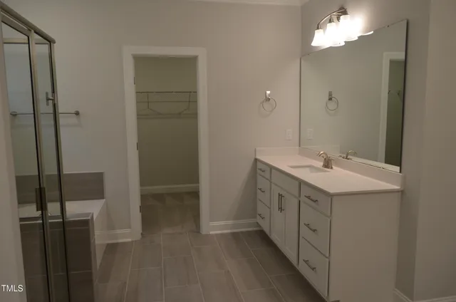 a bathroom with a double vanity sink and a mirror