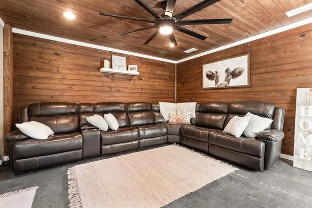 a living room with furniture and a brick wall