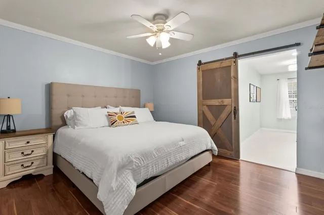 a bedroom with bed and a chandelier