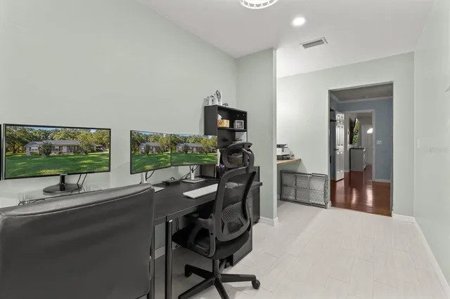 a view of a workspace with furniture and a window