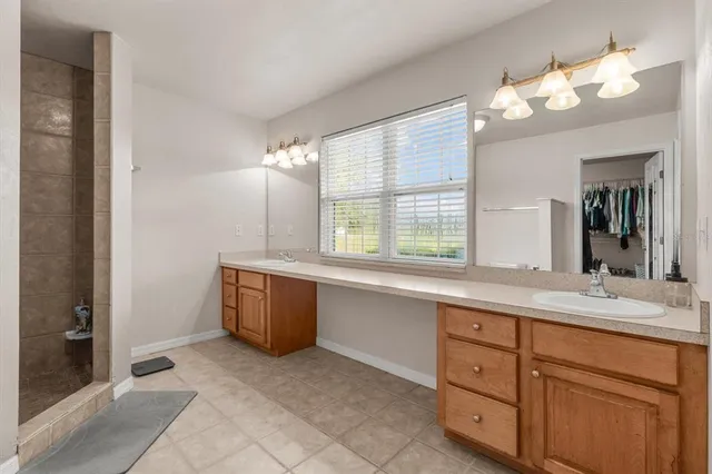 a bathroom with a sink vanity and mirror