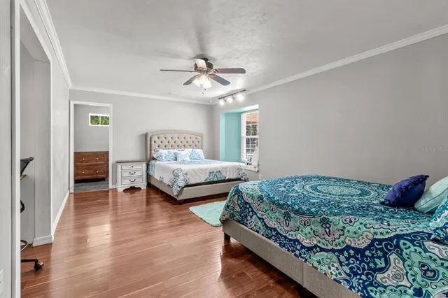 a bedroom with a bed and a chandelier