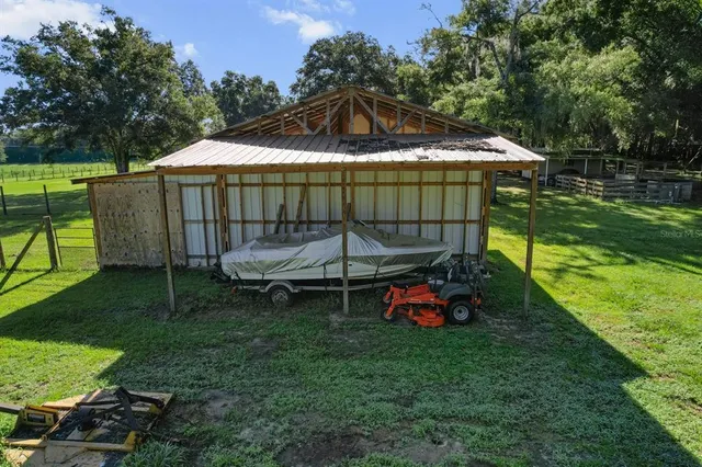 a backyard of a house with table and chairs