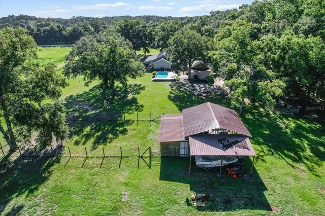 an aerial view of a house with yard table and chairs