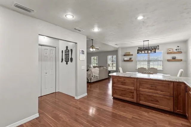 a room with a bed and a view of kitchen
