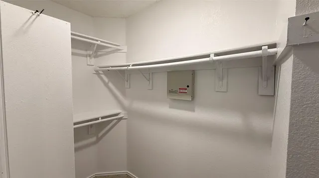 an empty room with a ceiling fan and a window