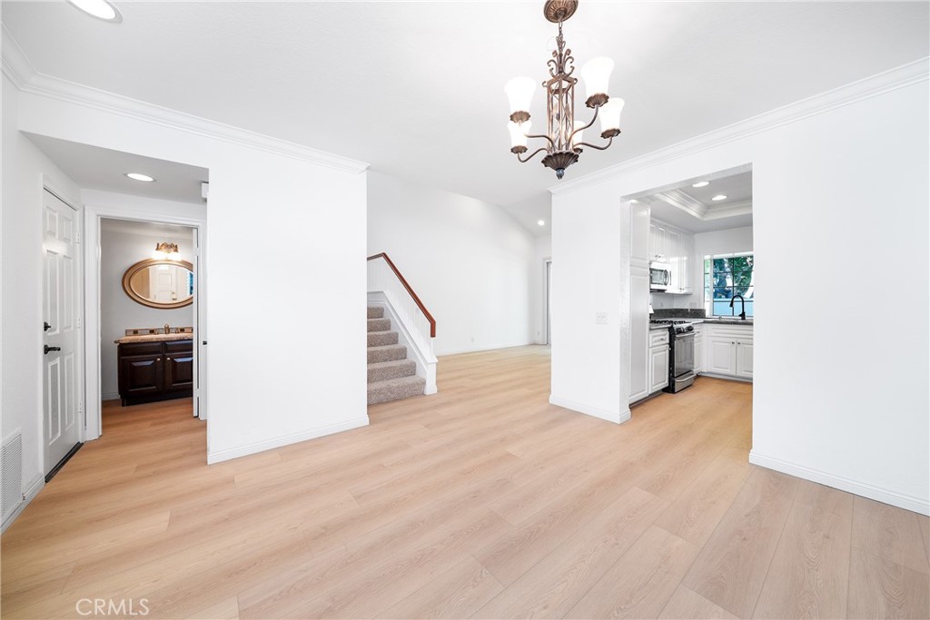 3 Almador Irvine, CA 92614 - Photo 2 of 35 a view of a hallway with wooden floor and a chandelier