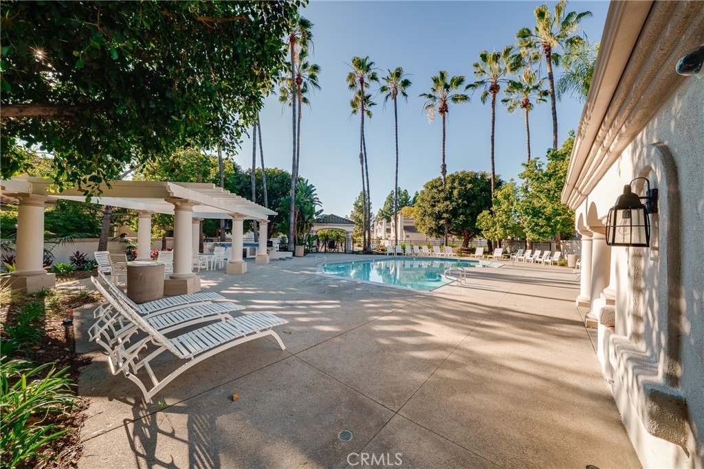 3 Almador Irvine, CA 92614 - Photo 32 of 35 a view of a patio with table and chairs under an umbrella with potted plants