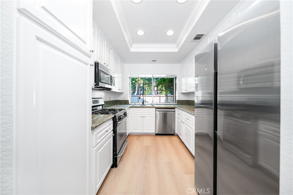 3 Almador Irvine, CA 92614 - Photo 4 of 35 a kitchen with stainless steel appliances a refrigerator sink and stove