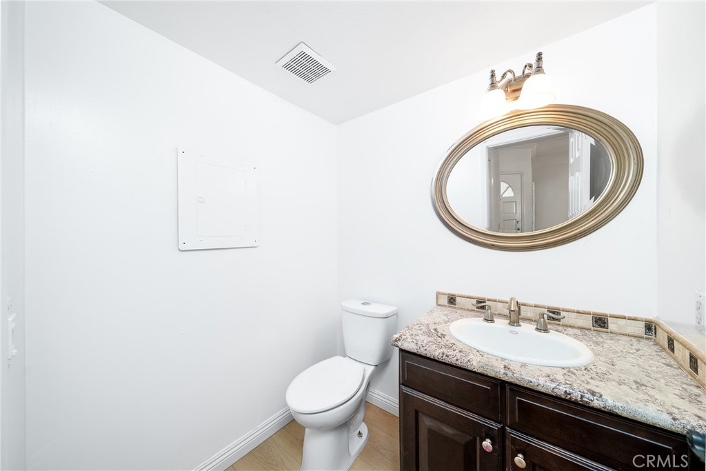 3 Almador Irvine, CA 92614 - Photo 10 of 35 a bathroom with a granite countertop toilet a sink and a mirror