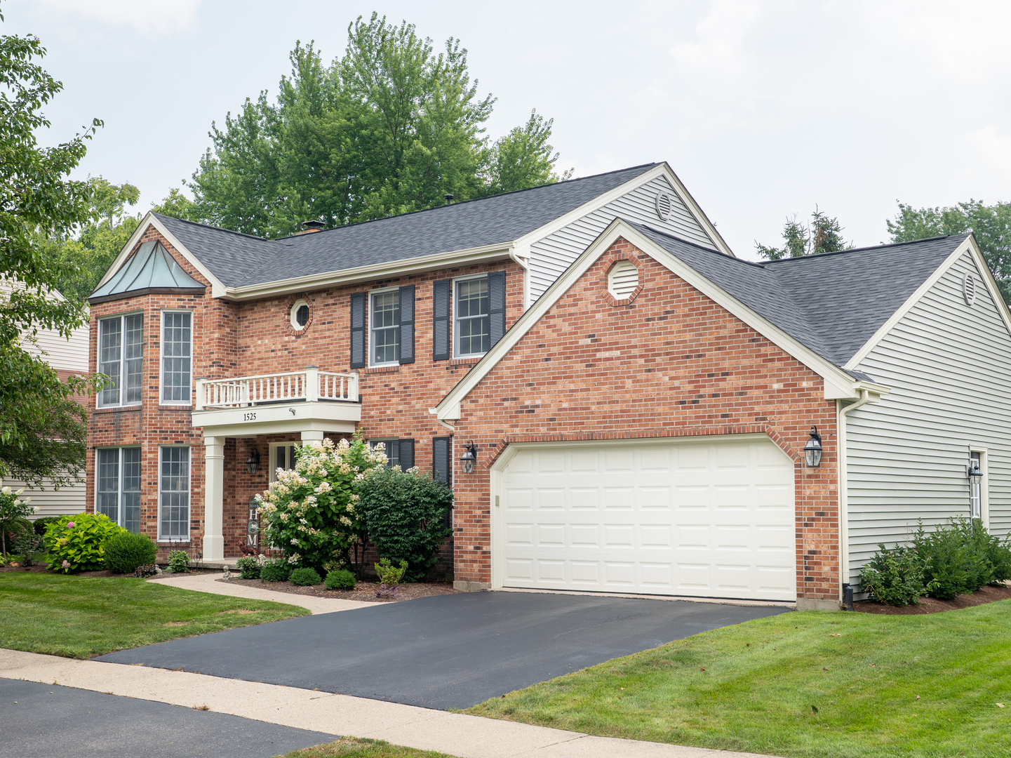1525 Forest Ridge Road St. Charles, IL 60174 - Photo 1 of 17 a front view of a house with a yard and garage