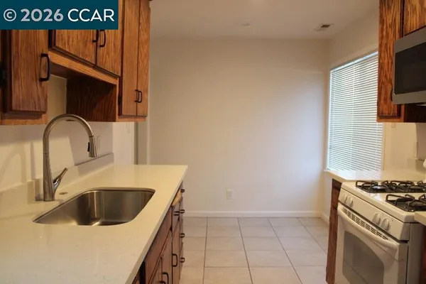 a kitchen with a sink a stove and a microwave