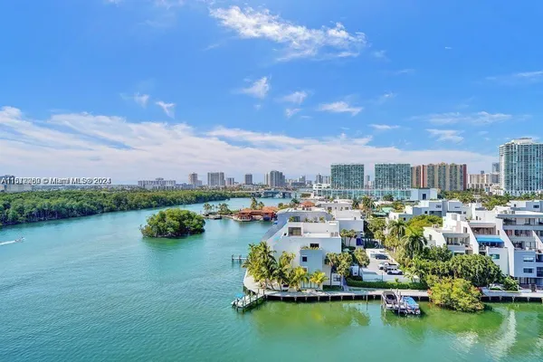 a city view with boat and palm trees