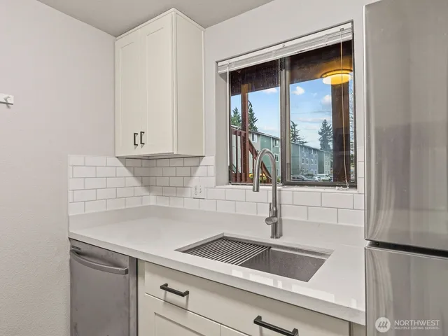 a kitchen with a sink and a window