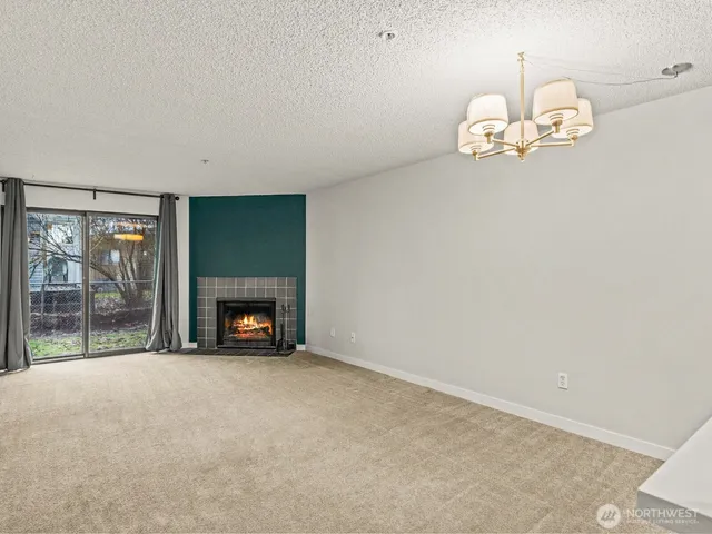 a view of an empty room with a fireplace