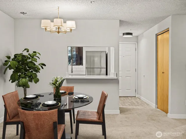 a view of a dining room with furniture and chandelier