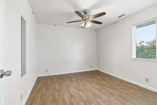 wooden floor in an empty room with a window