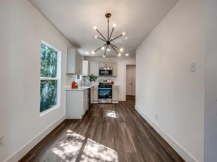 a kitchen with stainless steel appliances granite countertop a sink stove and wooden floors