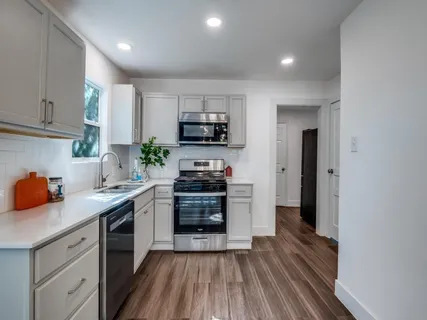 a kitchen with a sink stove and microwave