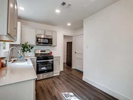a kitchen with a sink cabinets and stainless steel appliances