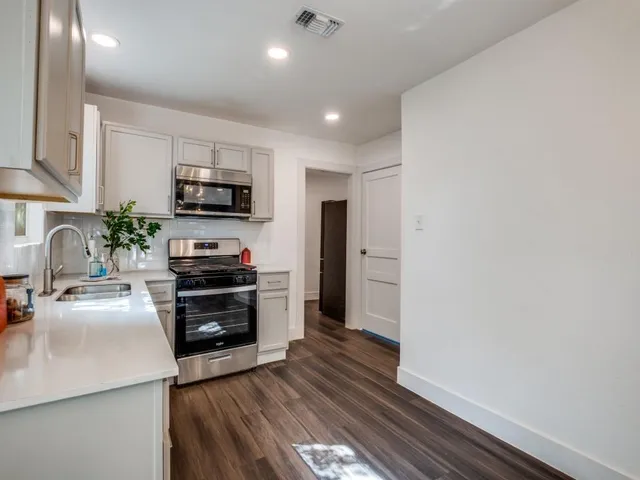 a kitchen with a sink cabinets and stainless steel appliances