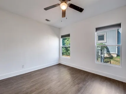 a kitchen with a refrigerator and a stove top oven