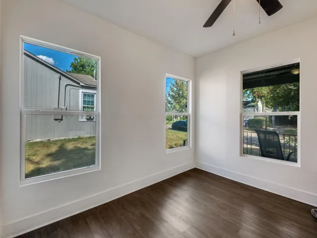 a view of room with window and wooden floor