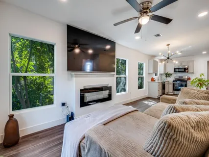 a bedroom with a bed a flat screen tv and a fireplace