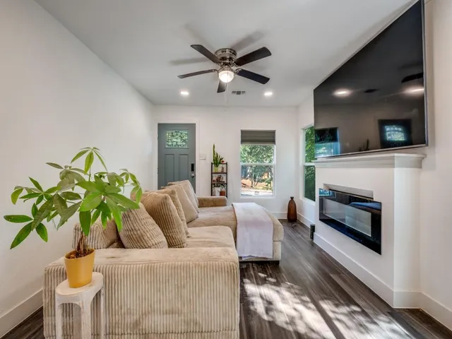 a living room with furniture a fireplace and a flat screen tv