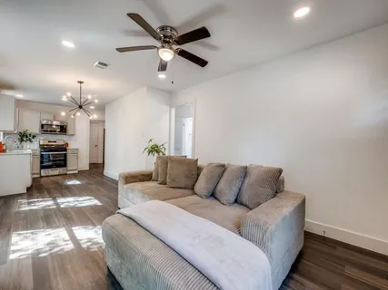 a living room with furniture and kitchen view