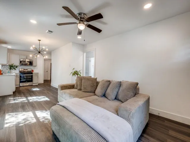 a living room with furniture and kitchen view