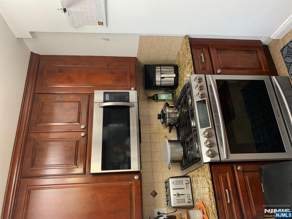 272 Wilson Avenue Fairview, NJ 07022 - Photo 13 of 15 a kitchen with granite countertop a stove and a microwave