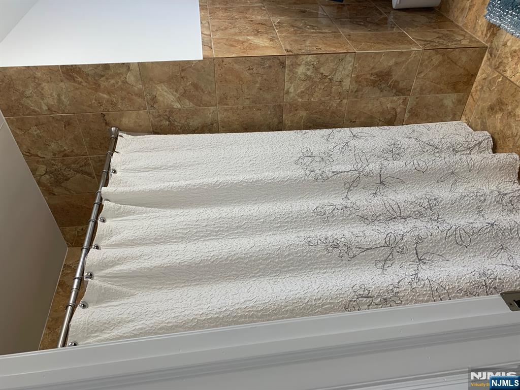 272 Wilson Avenue Fairview, NJ 07022 - Photo 14 of 15 a bathroom with a shower and a tub