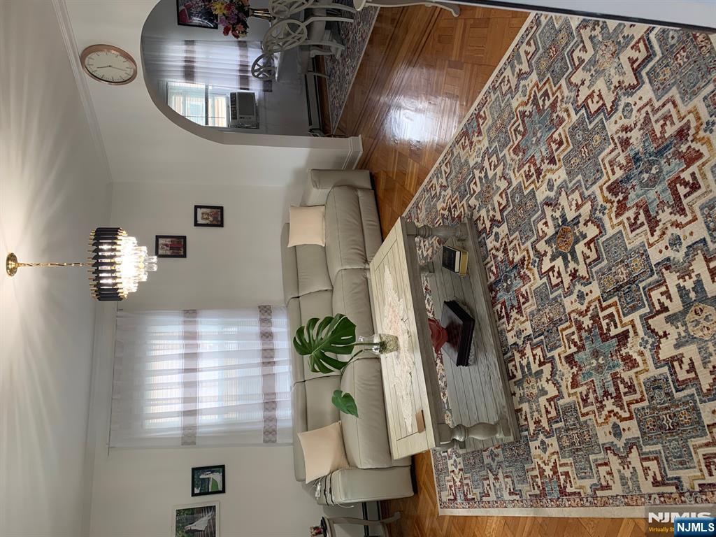 272 Wilson Avenue Fairview, NJ 07022 - Photo 2 of 15 a living room with furniture and a chandelier