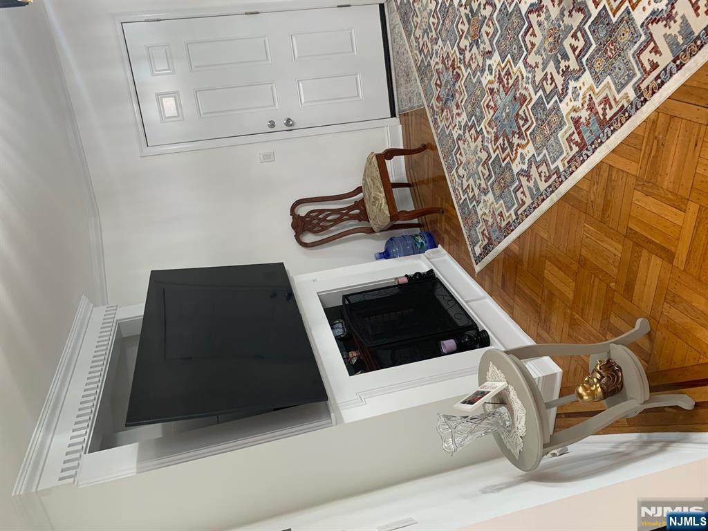 272 Wilson Avenue Fairview, NJ 07022 - Photo 4 of 15 a living room with a flat screen tv and rug