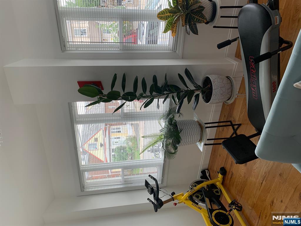 272 Wilson Avenue Fairview, NJ 07022 - Photo 5 of 15 a living room with furniture and a potted plant