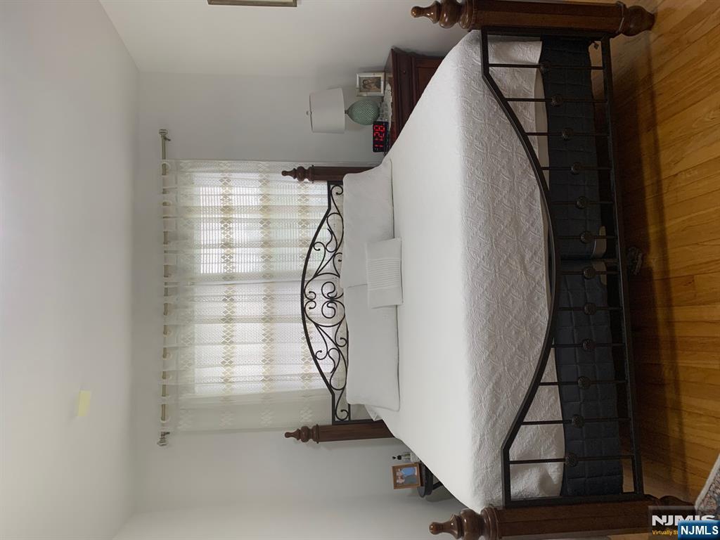 272 Wilson Avenue Fairview, NJ 07022 - Photo 8 of 15 a bedroom with a bed and window