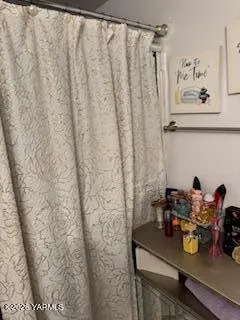 a view of backyard with wooden fence and large trees