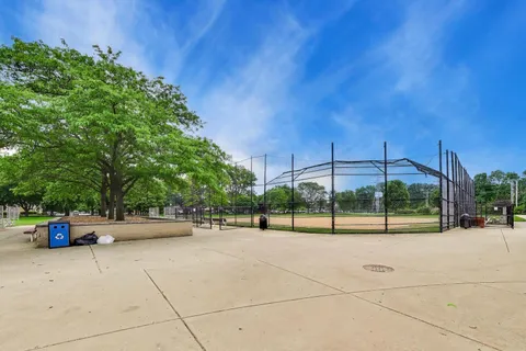 a view of a park with iron fence