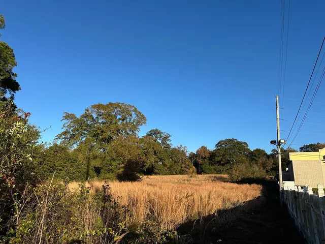 a view of a lake with a house and a big yard
