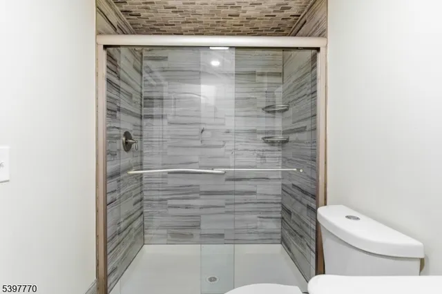 a bathroom with a toilet and a shower